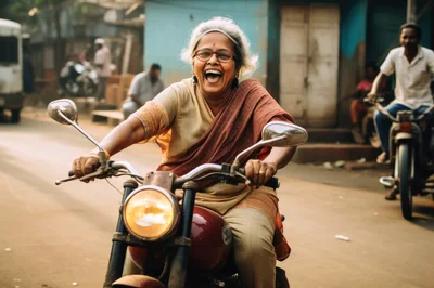 Joyful Elderly Indian Woman Riding A Motorcycle