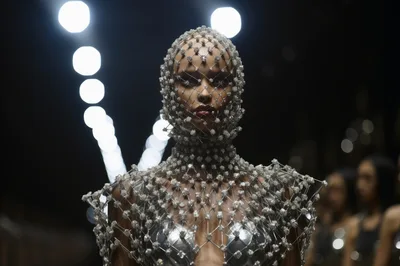 Model Wearing Intricate Beaded Headpiece On Fashion Runway