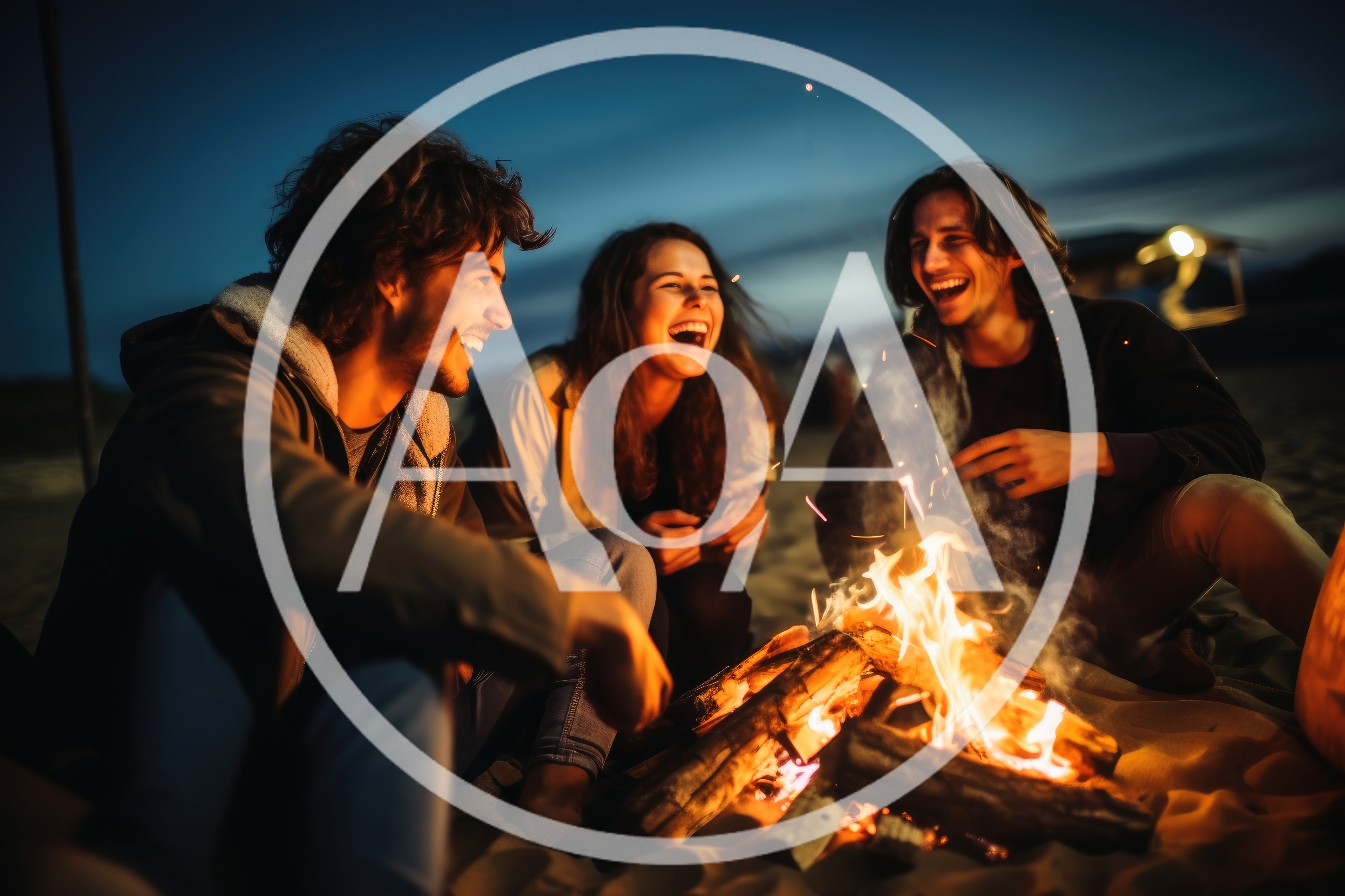 Friends Laughing Around A Beach Bonfire At Night