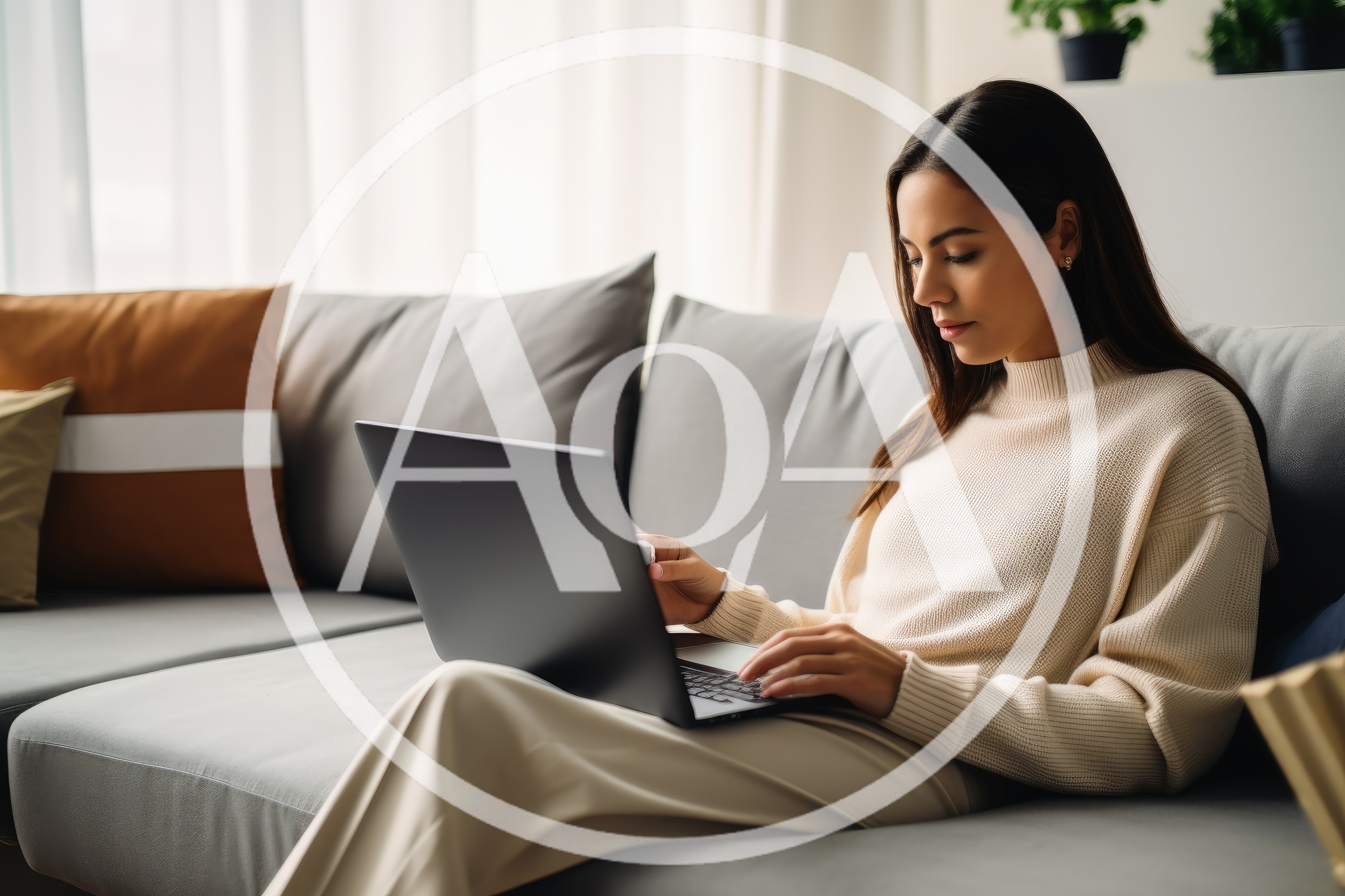 Young Woman Working On Laptop On A Sofa