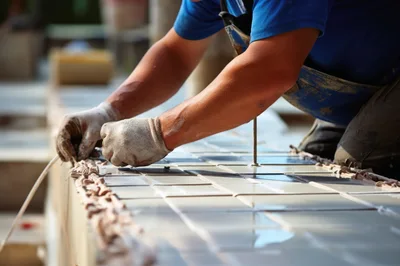 Construction Worker Installing Ceramic Tiles On A Surface
