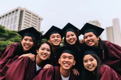 Group Of Happy Graduates Celebrating Success Outdoors