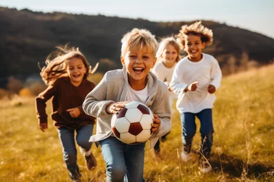 Group of Happy Children Running with Soccer Ball