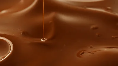 Liquid Chocolate Pouring Into A Smooth Pool