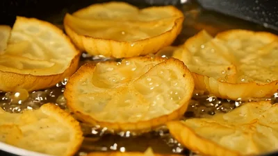 Slices Of Onion Frying In Hot Oil