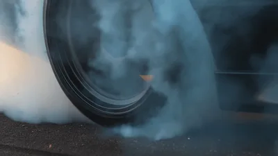 Car Tire Spinning And Creating Thick Smoke