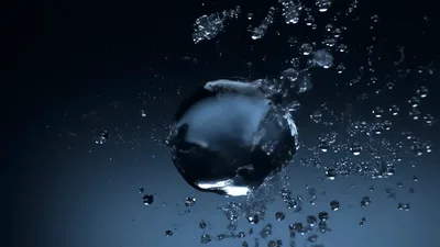 Water Sphere Exploding Into Droplets Against Dark Background
