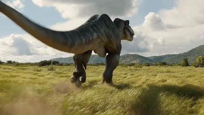 Tyrannosaurus Rex Running Through A Grassy Field