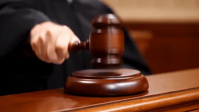 Judge Striking Wooden Gavel On Sound Block