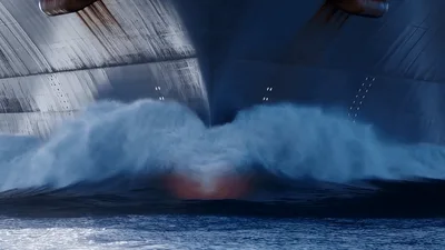 Large Cargo Ship Bow Cutting Through Ocean Waves