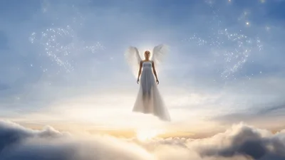 Angel With Large White Wings Floating Above Clouds