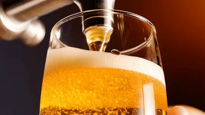 Golden Beer Pouring From Tap Into Glass