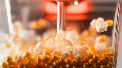 Popcorn Kernels Popping Inside A Glass Popcorn Maker