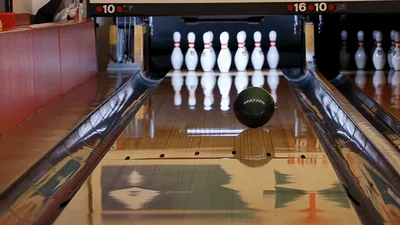 Bowling Ball Rolling Down Lane Toward Pins