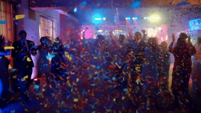 People Dancing At A Festive Party With Confetti