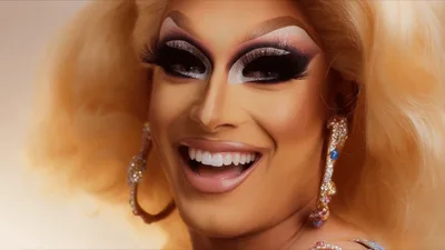 Drag Queen With Blonde Hair Smiling And Laughing
