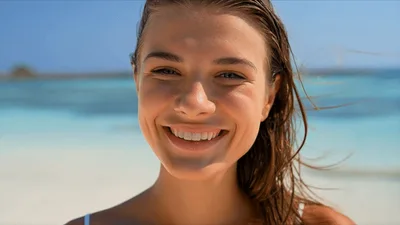 Smiling Young Woman Enjoying Sunny Day At Tropical Beach