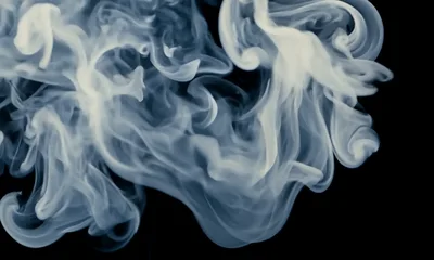 White Smoke Swirling Against A Black Background