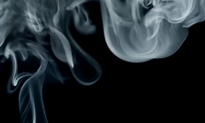 White Smoke Swirling Against A Black Background