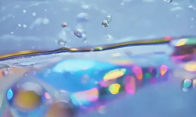 Abstract Liquid Surface With Iridescent Light Reflections