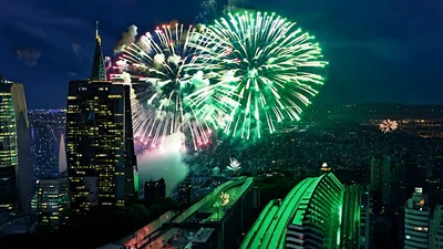 Fireworks Display Over Modern City Skyline At Night