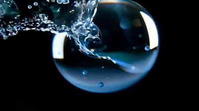Water Stream Impacting A Floating Liquid Sphere