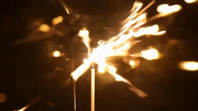 Sparkler Burning Brightly Against A Dark Background