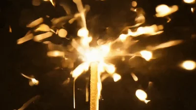 Sparkler Burning Brightly Against A Dark Background