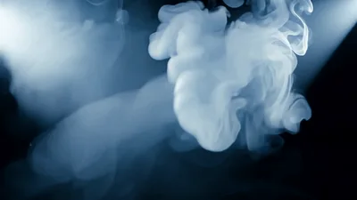 White Smoke Swirling In A Dark Spotlight