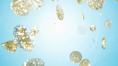 Golden Glittering Confetti Falling Against Light Blue Background