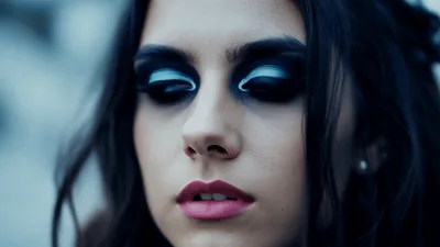 Young Woman With Dramatic Makeup Looking Downward