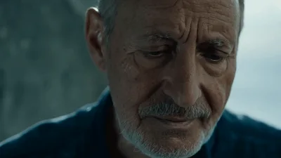Elderly Man With Gray Mustache Looking Down Thoughtfully