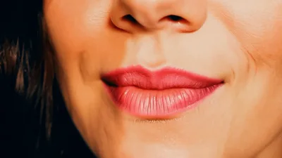 Close Up Of A Woman Smiling And Pouting Lips