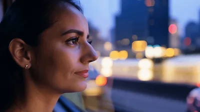 Young Woman Looking Out Of A Moving Car Window
