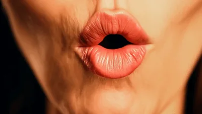 Close Up Of Woman Smiling And Pouting Lips