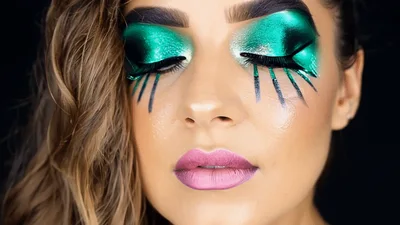 Woman With Artistic Green Eyeshadow And Painted Eyelashes