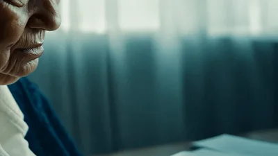 Elderly Woman Sitting Alone Near A Window