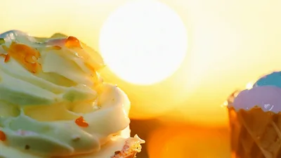 Two Ice Cream Cones Against A Golden Sunset