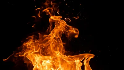 Bright Orange Flames Rising Against A Black Background
