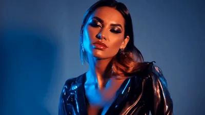 Glamorous Woman Posing In Shiny Black Latex Jacket