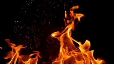 Bright Orange Flames Burning Against Black Background