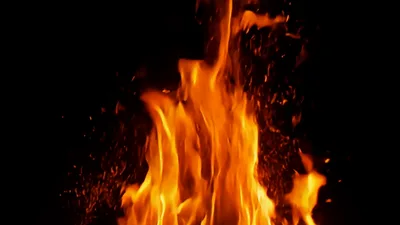 Bright Orange Flames Burning With Rising Embers