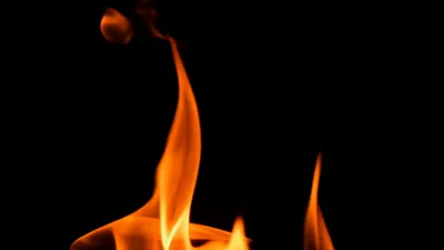 Bright Orange Flames Flickering Against A Black Background