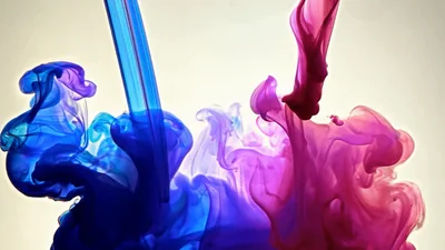 Blue And Red Ink Droplets Mixing In Water