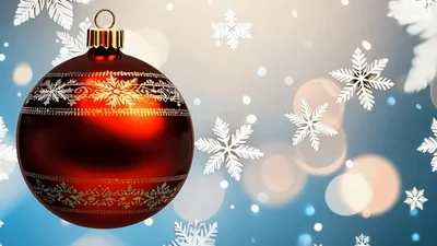 Red Christmas Ornament Hanging Against Falling Snowflakes