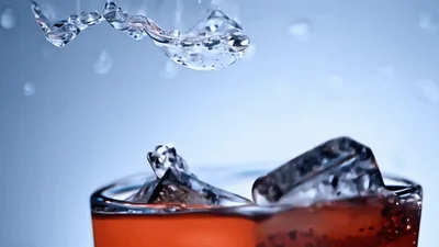 Ice Cubes Dropping Into A Glass Of Iced Tea