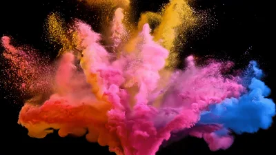 Colorful Powder Explosion Against Black Background
