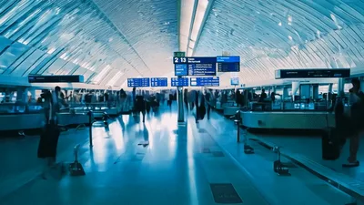 Commuters Walking Through A Modern Airport Terminal