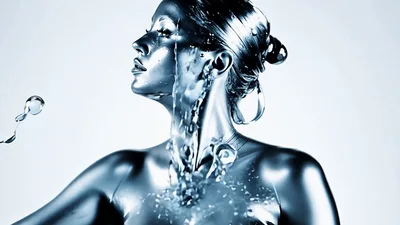 Liquid Silver Woman Posing With Flowing Metallic Fluid