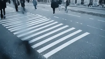 Pedestrians Walking Across A City Crosswalk In Time Lapse